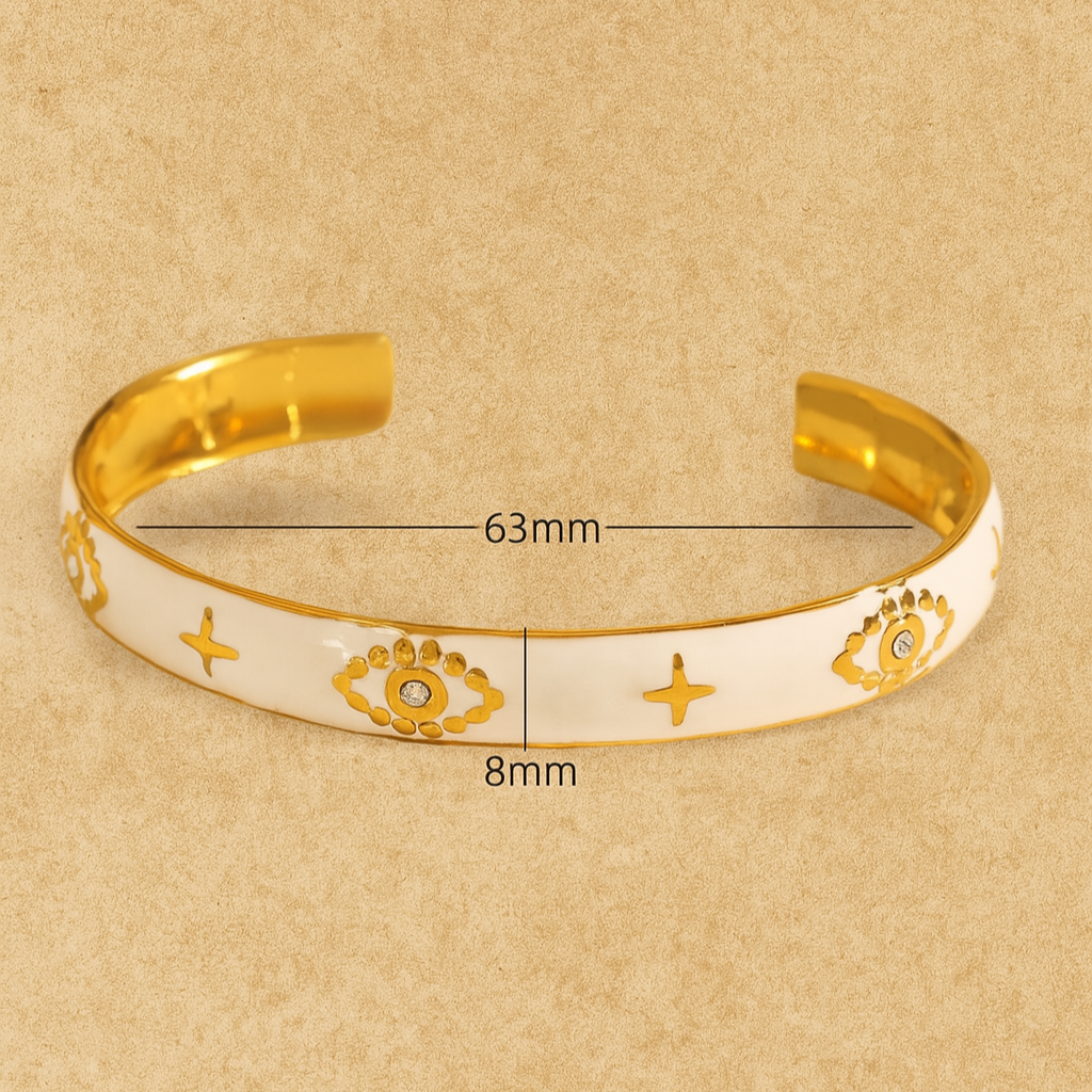 Gold bracelet with measurements on a beige background