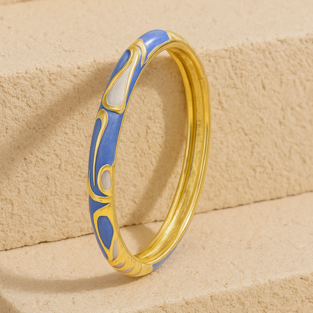 Gold ring with blue design on a beige stone surface