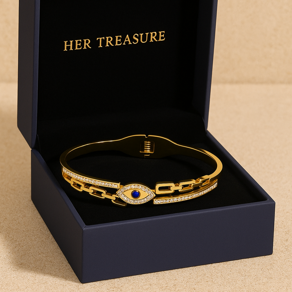 Gold bracelet with blue gemstone in a 'HER TREASURE' box on a beige background