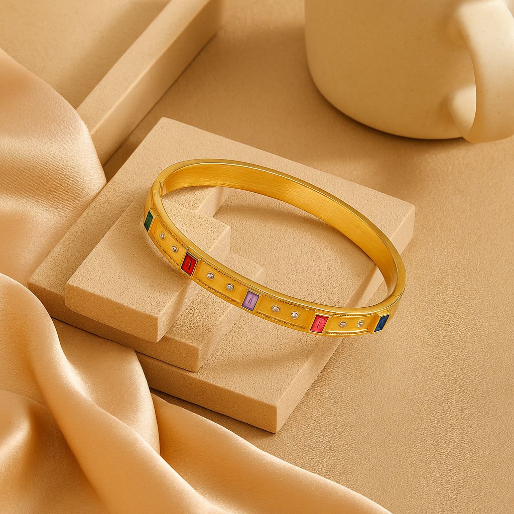 Gold bracelet with colorful stones on a beige fabric background