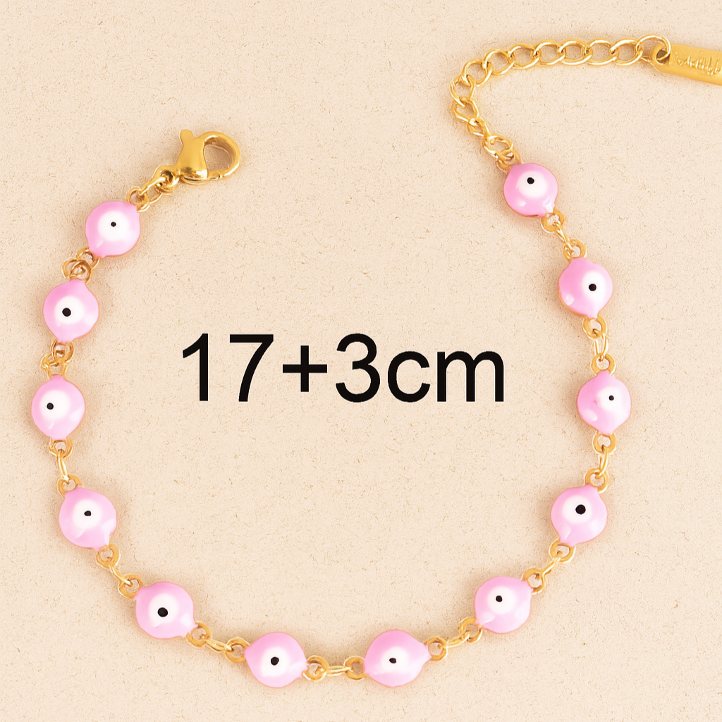 Gold bracelet with pink beads on a beige background