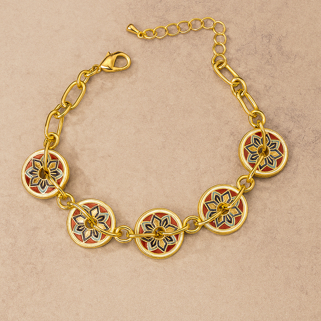 Gold bracelet with floral designs on a beige background