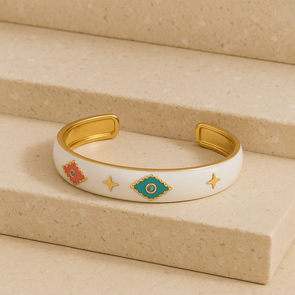 Decorative gold and white bracelet on a beige surface