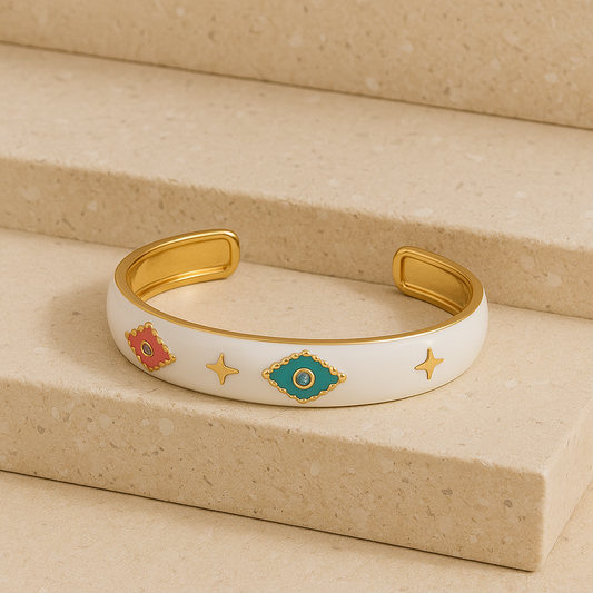 Decorative gold and white bracelet on a beige surface