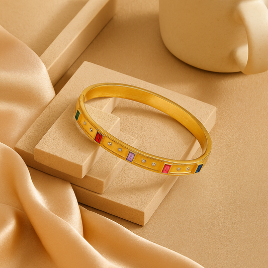 Gold bracelet with colorful stones on a beige fabric background