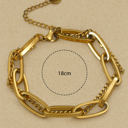 Gold chain bracelet on a beige background with measurement label